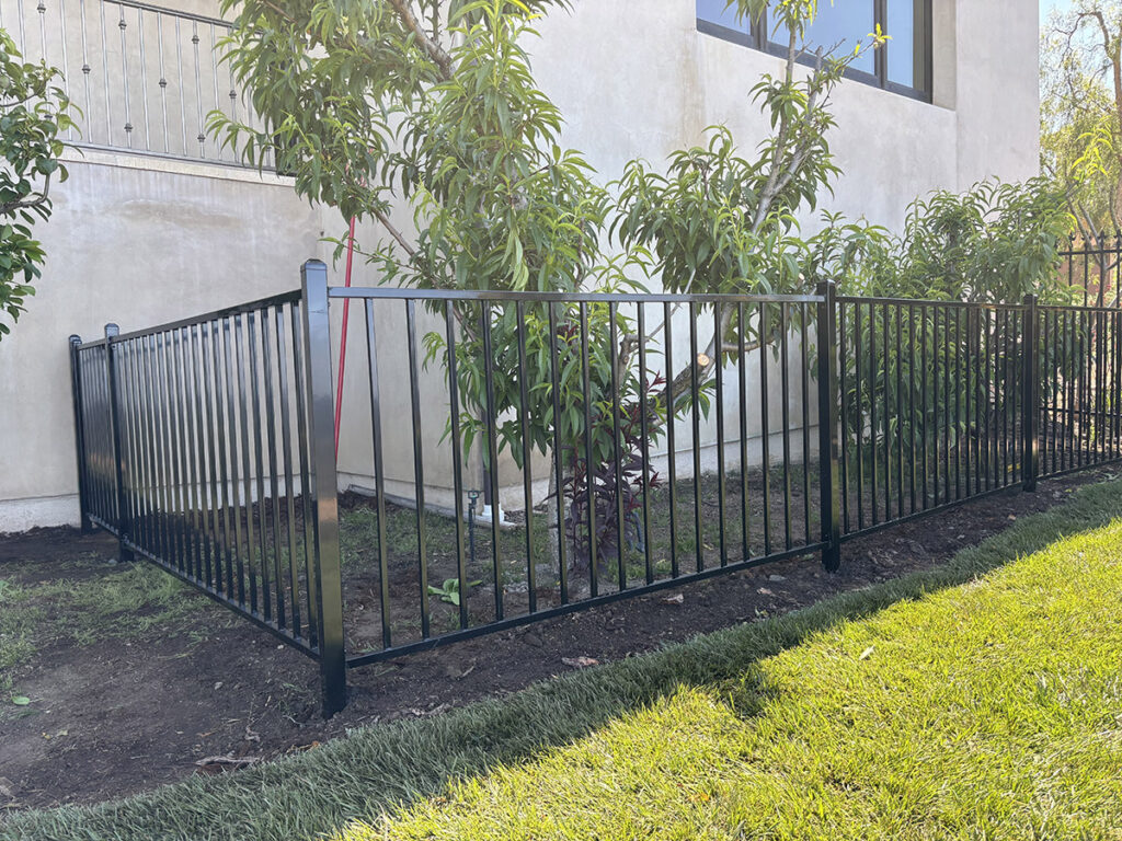 Custom wrought iron fencing along a residential property line