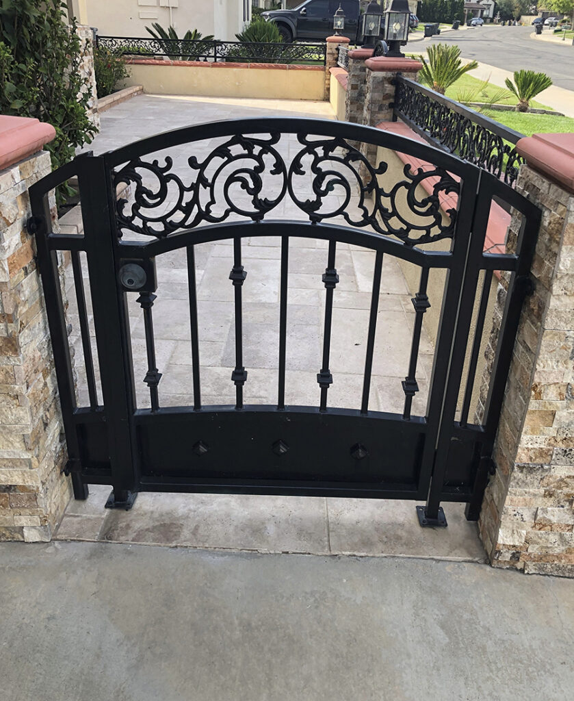 Custom ornamental iron and wood driveway gate